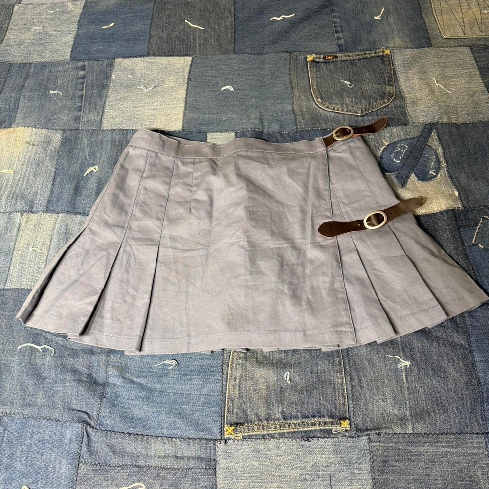 Adjustable pleated mini skirt with leather straps